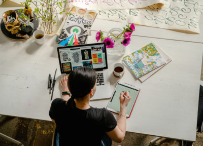 woman using tablet and laptop computer