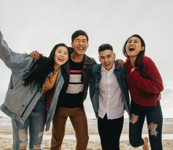 Group of friends having fun at beach