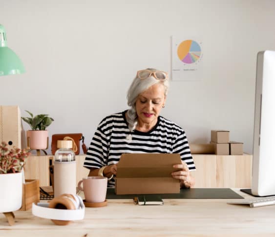 Woman sitting at a desk working on her laptop.