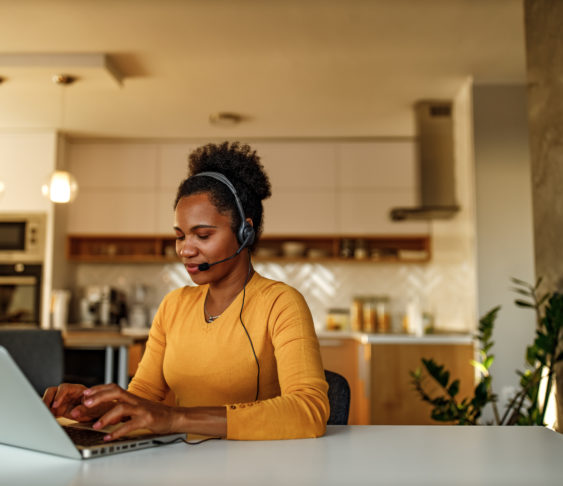 Woman setting at her desk working on a laptop