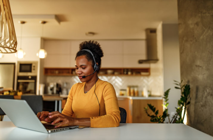 Woman setting at her desk working on a laptop