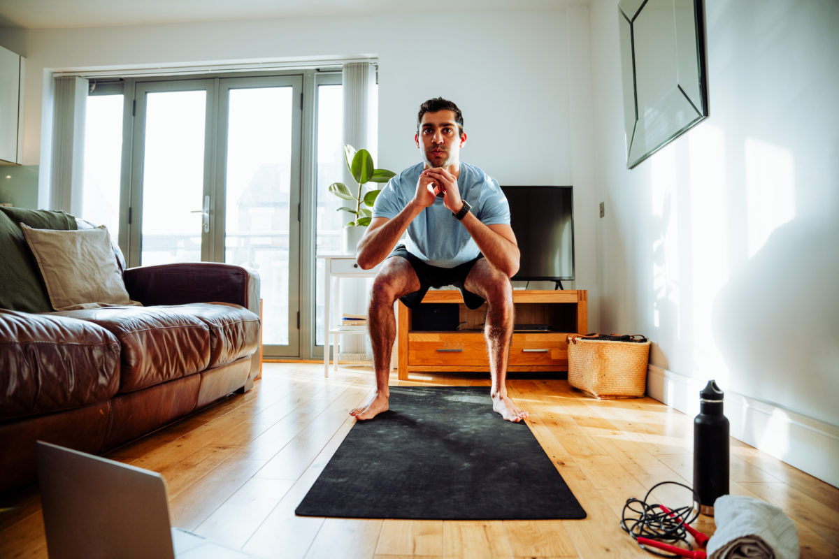 Man using technology to work out at home