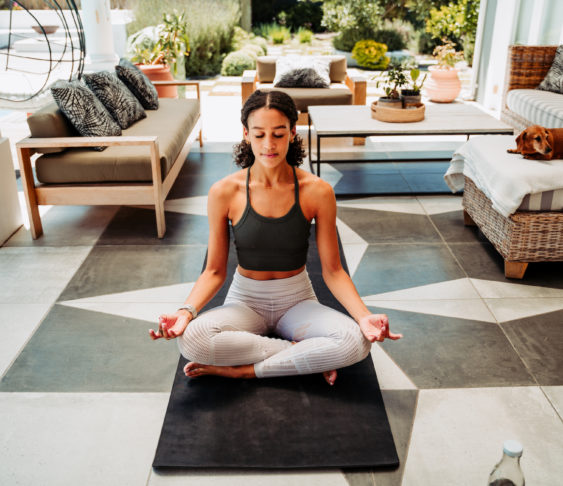 Woman practicing yoga at home