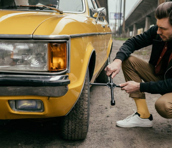 Young man fixes vehicle